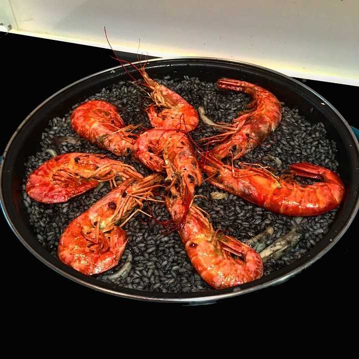 Arroz negro com vieiras e camarões fumados